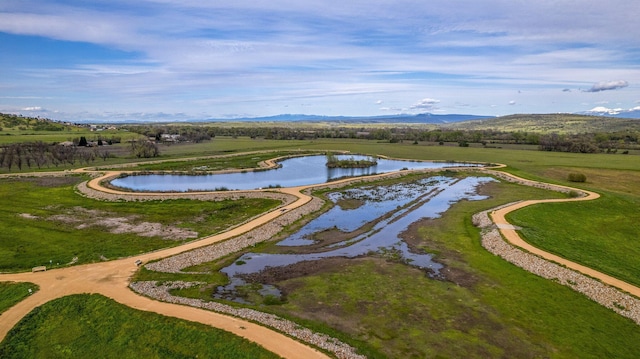 birds eye view of property featuring a water and mountain view