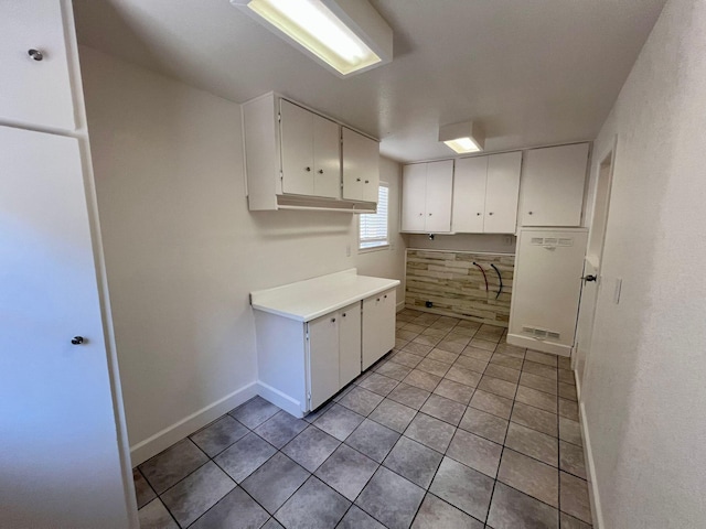 kitchen with white cabinetry and light tile patterned floors