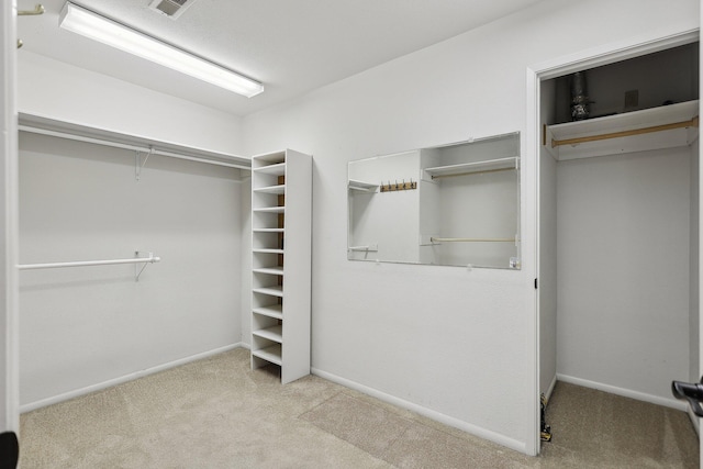 spacious closet with carpet floors and visible vents