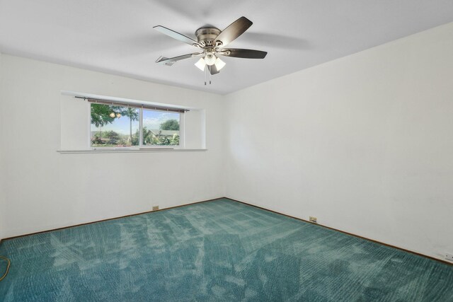 unfurnished room with carpet flooring and a ceiling fan