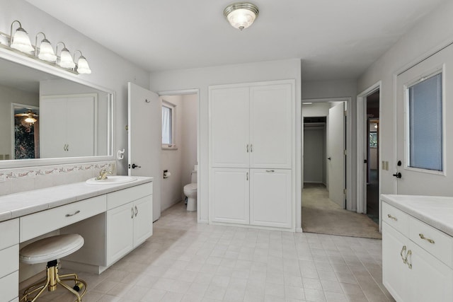 bathroom with tile patterned floors, vanity, and toilet