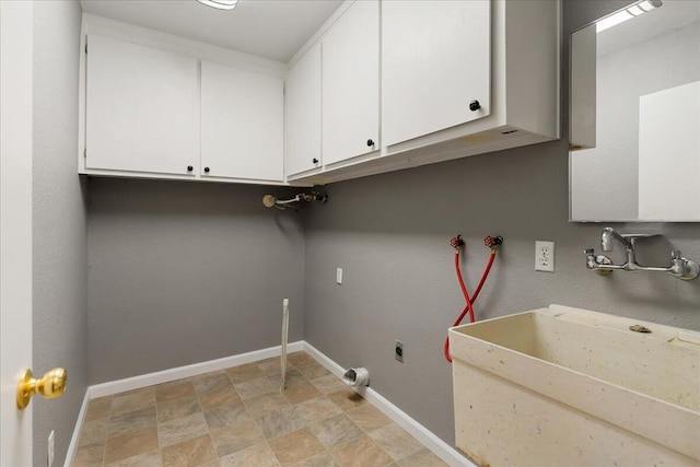 laundry room featuring cabinets, washer hookup, and sink