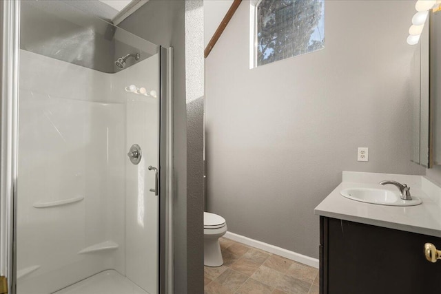 bathroom with vanity, toilet, and a shower with shower door