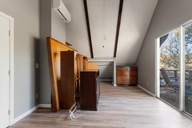 additional living space featuring a wall mounted air conditioner, vaulted ceiling, and light wood-type flooring