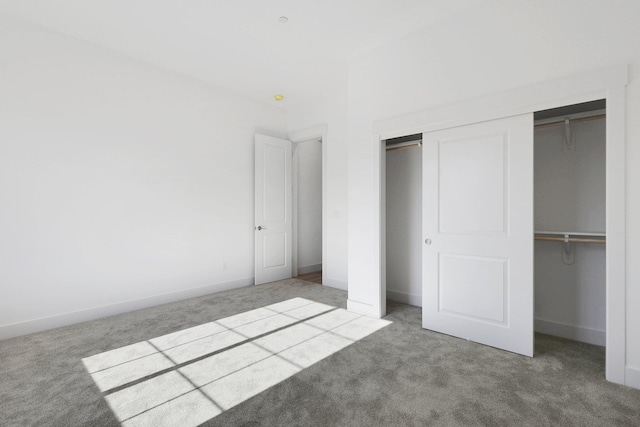 unfurnished bedroom featuring carpet flooring and a closet