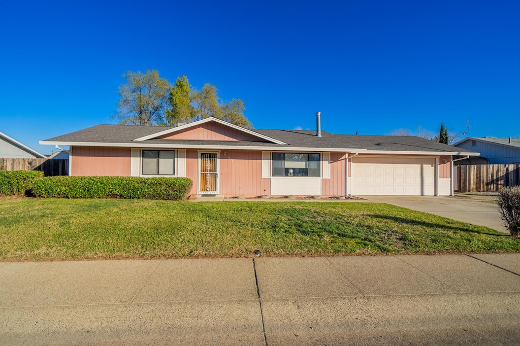 ranch-style home with a garage and a front yard