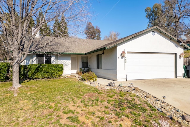 ranch-style home with a garage and a front yard