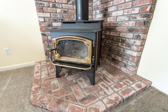 room details with carpet and a wood stove