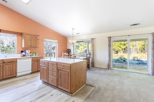 kitchen with vaulted ceiling, a chandelier, hanging light fixtures, a center island, and white dishwasher