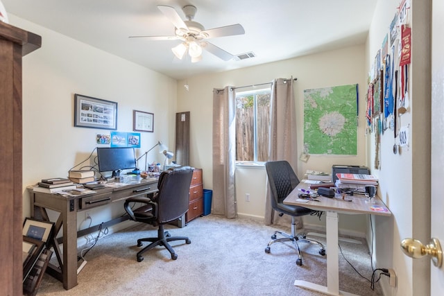 office space with light carpet and ceiling fan