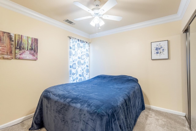 bedroom featuring ornamental molding, light carpet, and ceiling fan