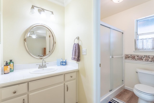 bathroom featuring vanity, hardwood / wood-style floors, toilet, and walk in shower