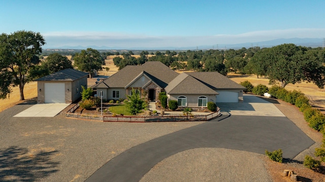 ranch-style house featuring a garage and an outdoor structure