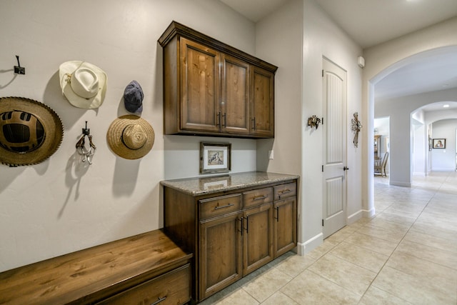 hall featuring light tile patterned floors