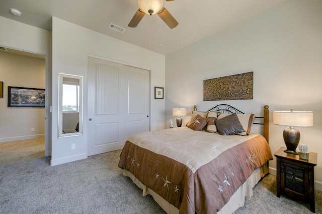 bedroom with ceiling fan, a closet, and light carpet