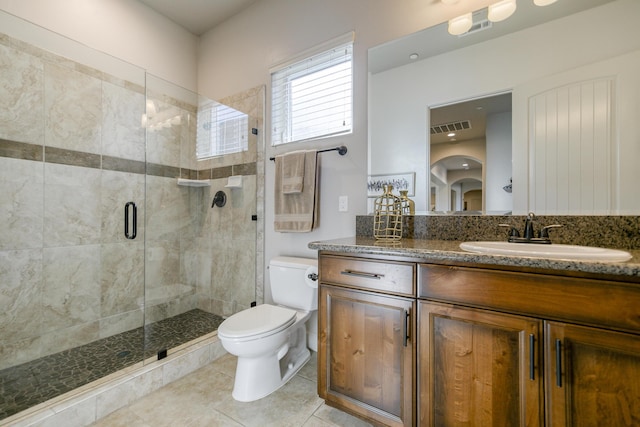 bathroom featuring vanity, an enclosed shower, tile patterned floors, and toilet