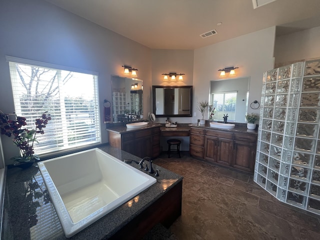 bathroom featuring vanity and a bath