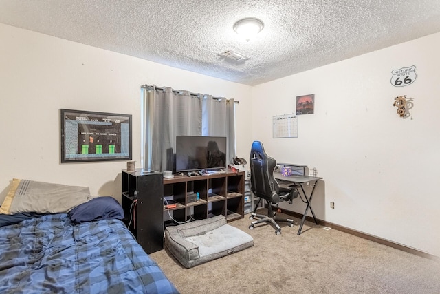 bedroom featuring carpet floors and a textured ceiling