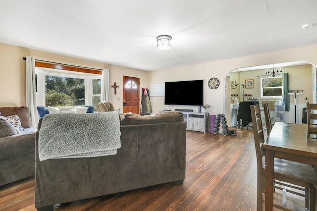 living room featuring dark hardwood / wood-style flooring and a chandelier