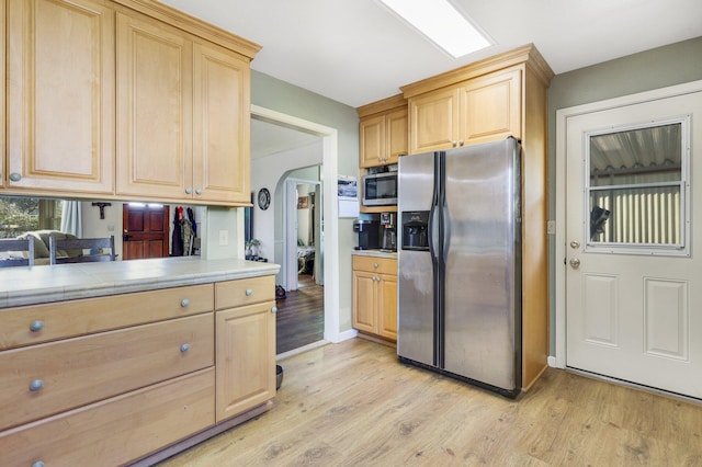 kitchen featuring stainless steel fridge with ice dispenser, light hardwood / wood-style floors, and light brown cabinets