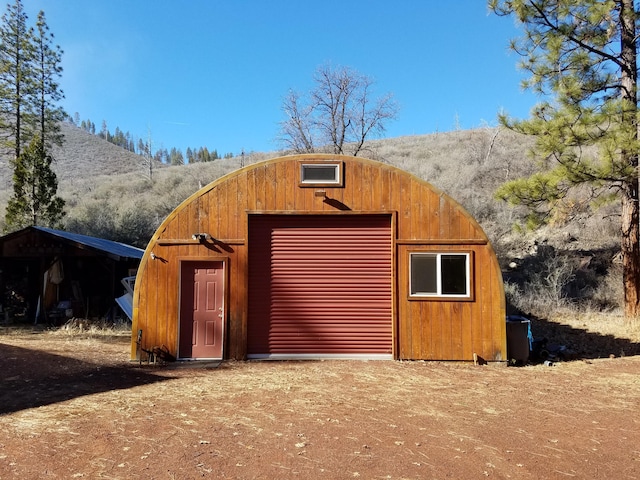 view of outbuilding featuring an outdoor structure and a mountain view