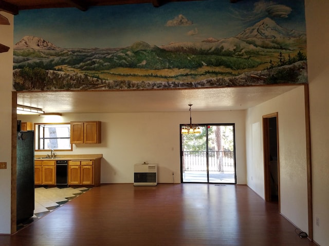 interior space featuring heating unit, light wood-style floors, freestanding refrigerator, a sink, and a chandelier