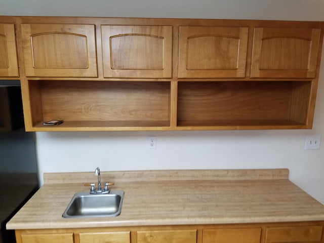 kitchen featuring light countertops and a sink