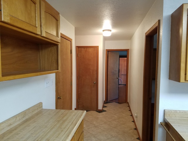 kitchen with light countertops and light tile patterned flooring