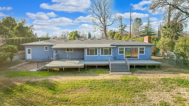 rear view of house with a yard and a deck