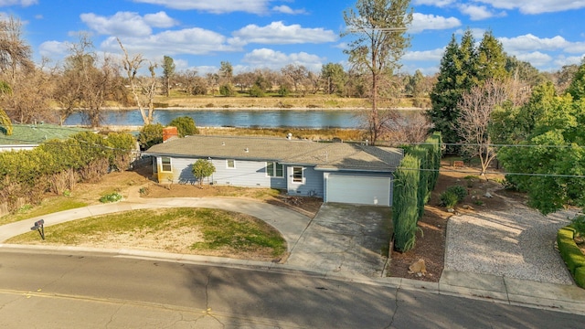 view of front facade featuring a water view and a garage