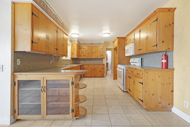 kitchen featuring light tile patterned floors, white appliances, and decorative backsplash