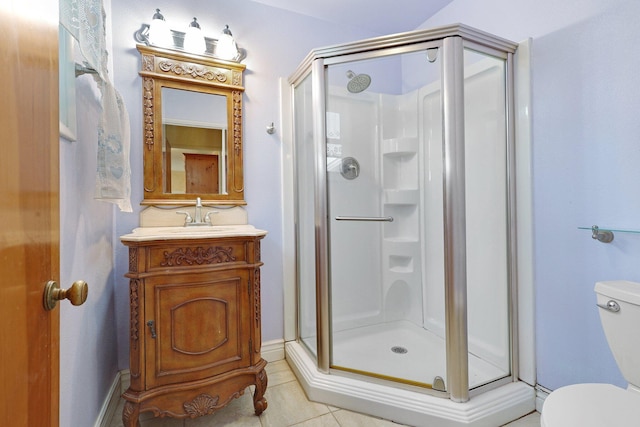 bathroom featuring vanity, tile patterned flooring, toilet, and walk in shower