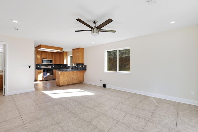 kitchen featuring ceiling fan, stainless steel appliances, tasteful backsplash, light tile patterned flooring, and kitchen peninsula