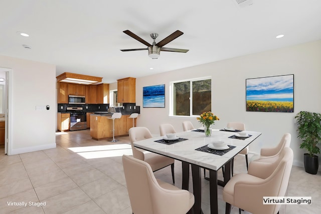 tiled dining space featuring ceiling fan