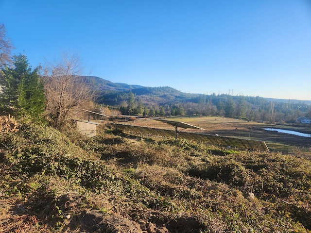 view of mountain feature featuring a rural view and a water view