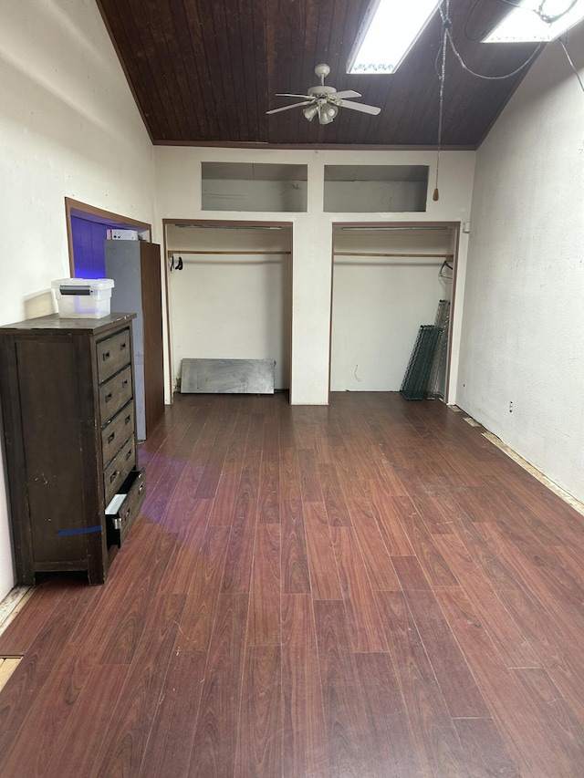 unfurnished bedroom featuring multiple closets, dark hardwood / wood-style floors, and wooden ceiling