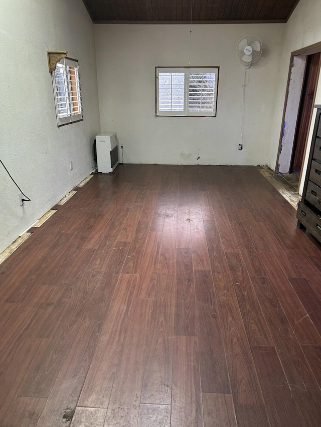 unfurnished room featuring wood-type flooring and a healthy amount of sunlight