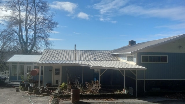 rear view of property with a carport