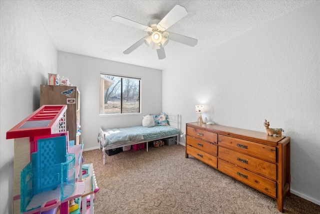 bedroom featuring ceiling fan, a textured ceiling, and carpet flooring