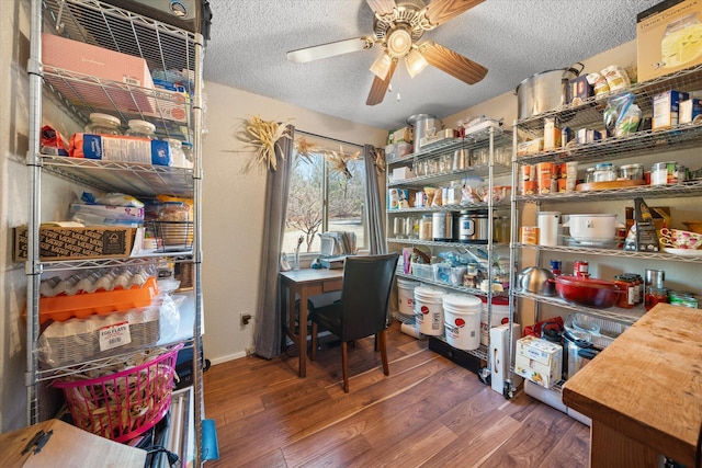 home office with ceiling fan, dark wood-type flooring, and a textured ceiling