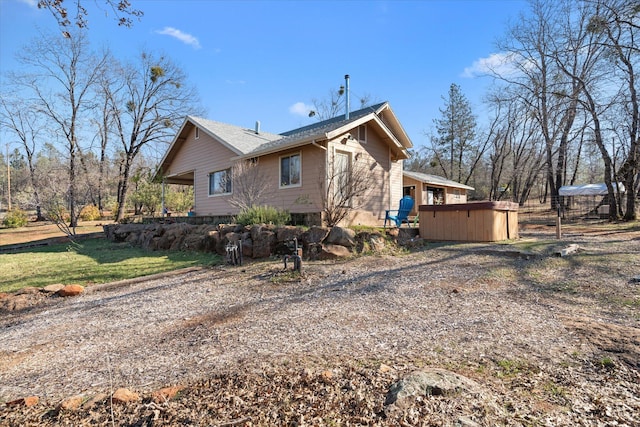 view of side of home featuring a jacuzzi