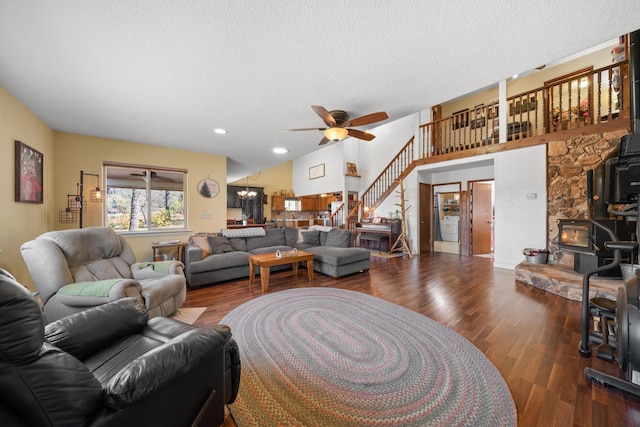 living room with ceiling fan, a textured ceiling, and dark hardwood / wood-style flooring