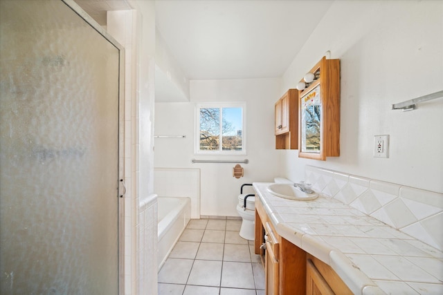 full bathroom featuring vanity, separate shower and tub, tile patterned floors, and toilet