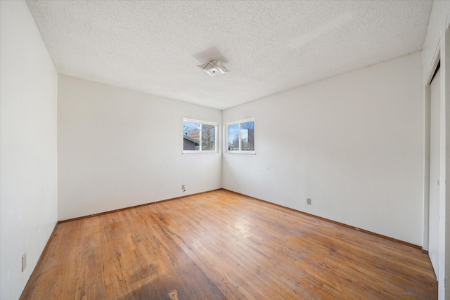 empty room featuring hardwood / wood-style floors and a textured ceiling