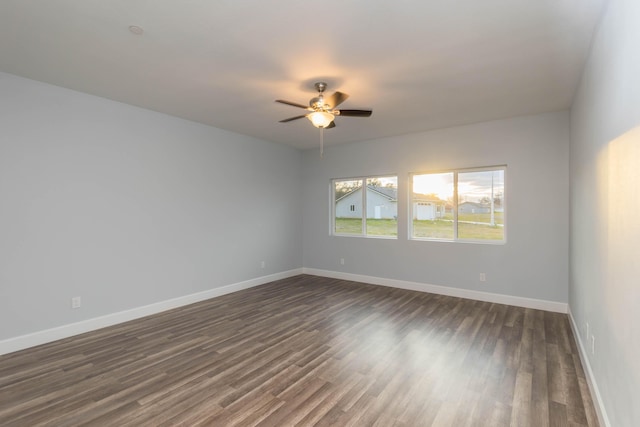 empty room featuring dark hardwood / wood-style floors and ceiling fan