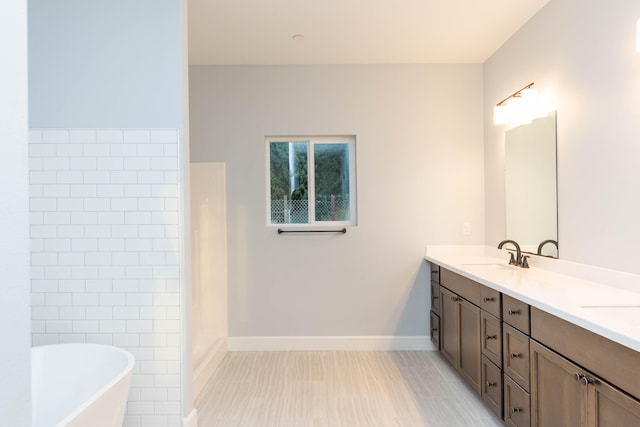 bathroom featuring a tub to relax in and vanity