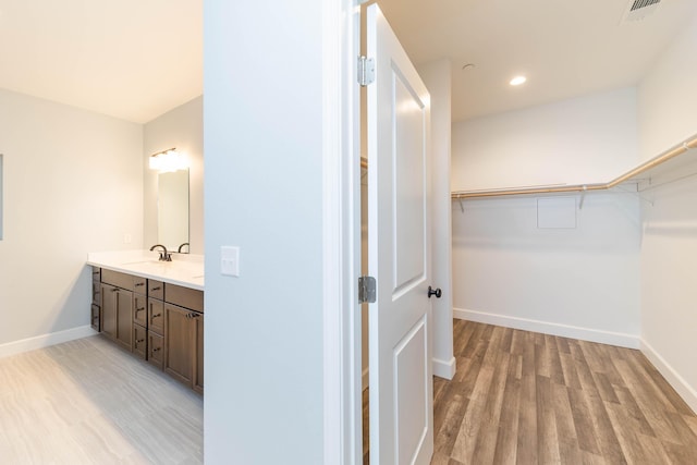 bathroom featuring hardwood / wood-style flooring and vanity