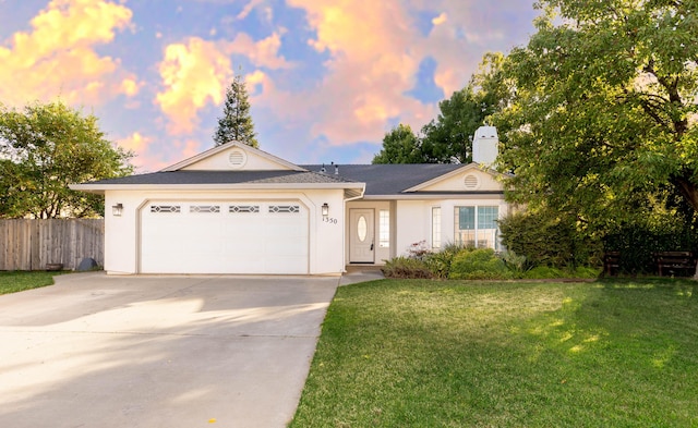 ranch-style home featuring fence, driveway, an attached garage, stucco siding, and a front lawn