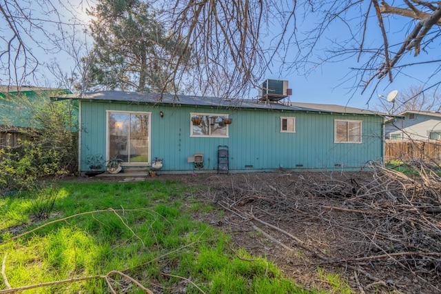 rear view of property with central AC unit