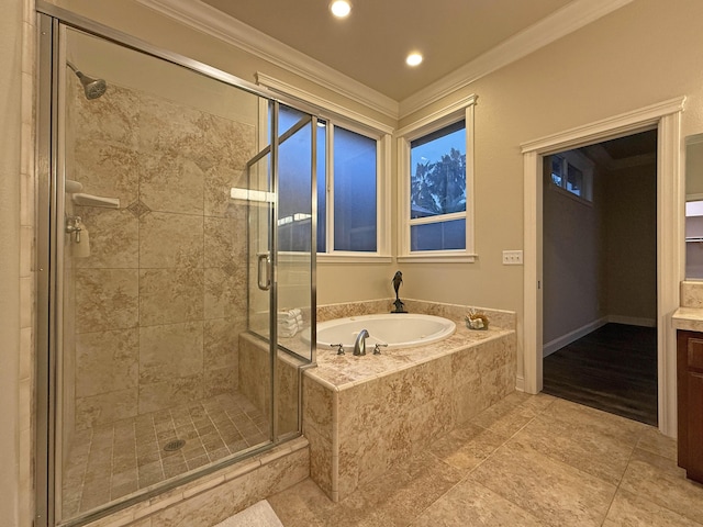 bathroom with vanity, ornamental molding, and separate shower and tub